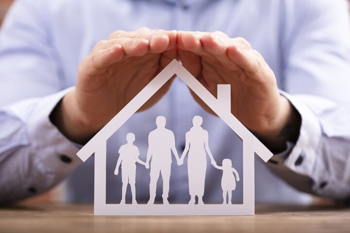 Businessman Protecting Family Home