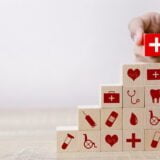 Health Insurance Concept,hand arranging wood block stacking with