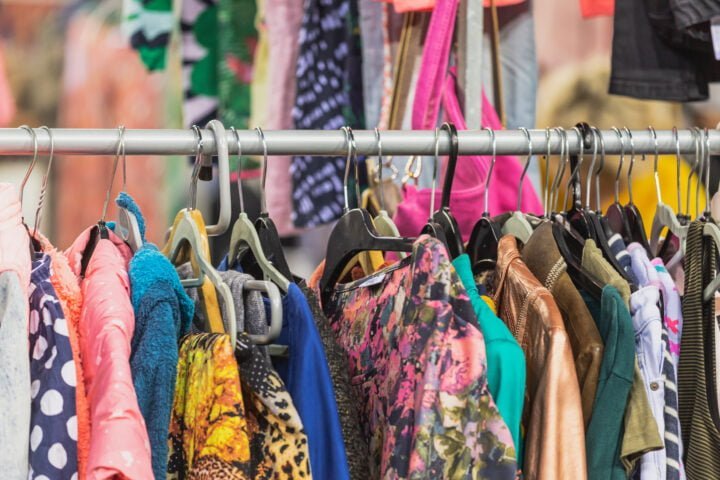 Second-hand clothing hanging on rail