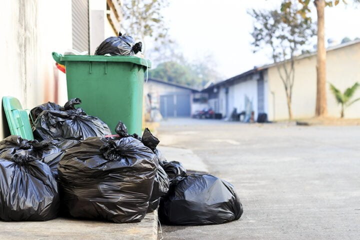 black garbage bag  with old brick wall background