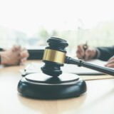 Judge gavel with Justice lawyers having team meeting at law firm