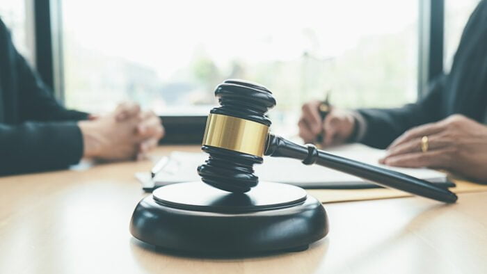 Judge gavel with Justice lawyers having team meeting at law firm