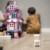 White wooden toy chair on a hardwood floor indoor room with chil