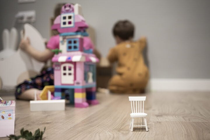 White wooden toy chair on a hardwood floor indoor room with chil