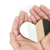 Male hands holding multicolored heart shape. Support All Lives M