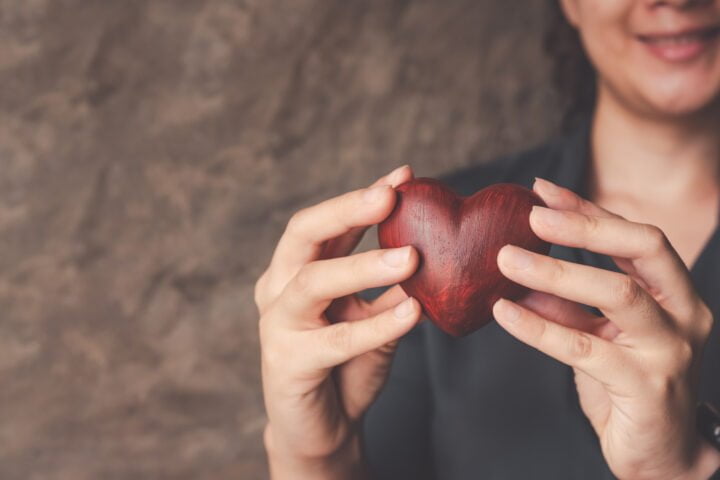 female hands holding red heart, world mental health day and world heart day, Life and health insurance, concept of love.