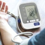Man check blood pressure monitor and heart rate monitor with dig