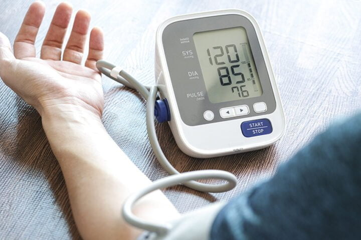 Man check blood pressure monitor and heart rate monitor with dig