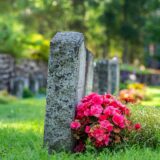 Row of grave stones with flowers at a cemetery in Sweden