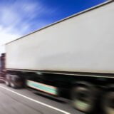 Generic big trucks speeding on the highway at sunset - Transport industry concept , big truck containers