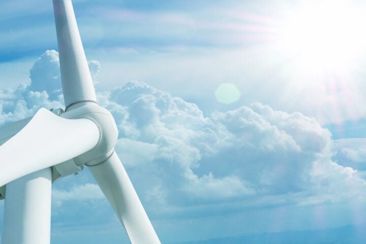 big wind turbine on blue sky background