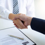 Business people shake hands to congratulate new employees in int