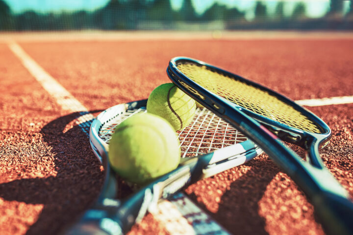 Tennis ball with racket on the tennis court. Sport, recreation c