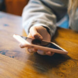 A young girl in a cafe uses the phone.