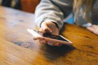 A young girl in a cafe uses the phone.