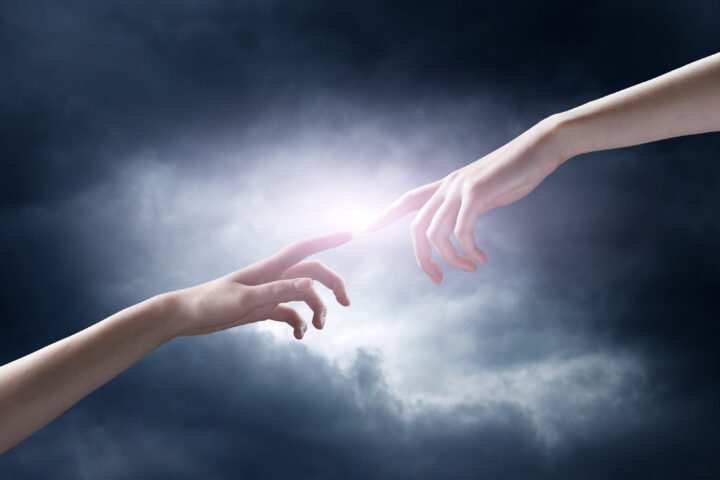 religion concept. finger touching the magic sky