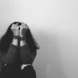 Hands of victim woman tied up with rope in emotional stress and pain, abused,wait for help