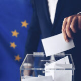 EU elections. Man throwing his vote into the ballot box.
