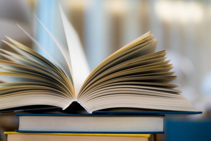 Open book lying on the table in the library