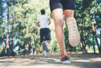 Young couple running in the park.
