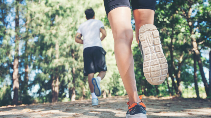 Young couple running in the park.