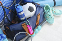 Set of sport equipment on floor near color wall