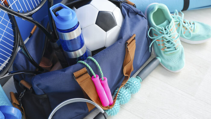 Set of sport equipment on floor near color wall