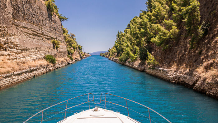 Passing through the Corinth Canal by yacht, Greece. The Corinth Canal connects the Gulf of Corinth with the Saronic Gulf in the Aegean Sea.