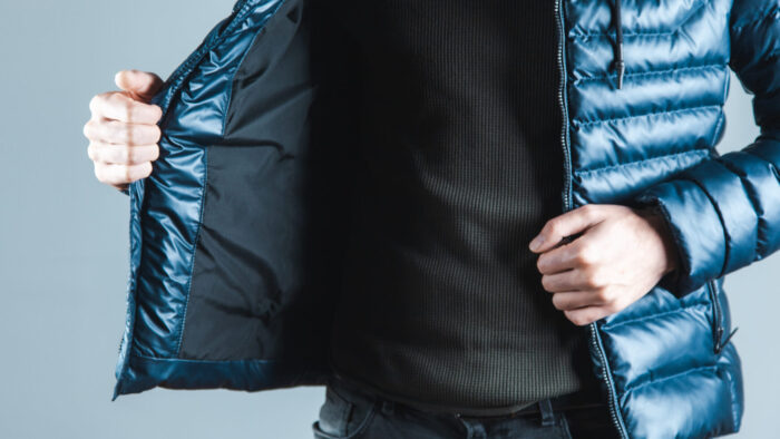 man hand  jacket on gray background