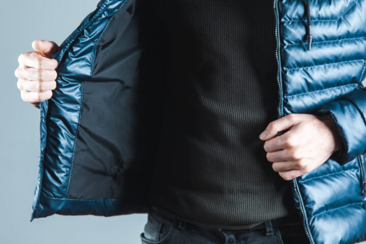 man hand  jacket on gray background